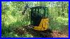 Moving-Brush-And-Digging-Up-A-Stump-With-The-John-Deere-30g-Mini-Excavator-01-ls